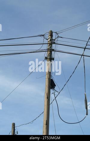 An electricity poles full of wire with blue sky on background in the early morning at the garden Stock Photo