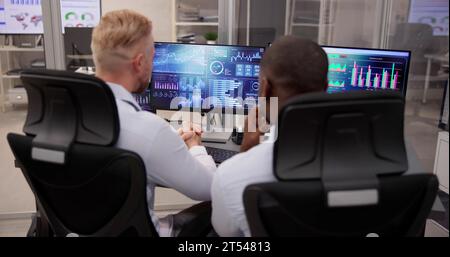 African American Data Analyst Using Data Analytics KPI Dashboard Stock Photo