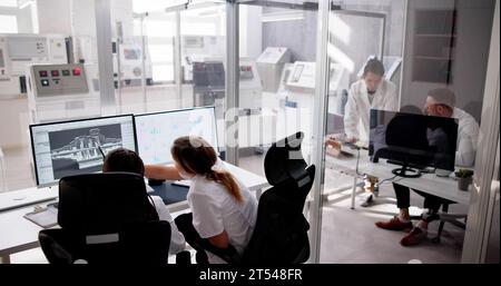 Engineer Doing 3D CAD Model Design On Computer At Factory Stock Photo