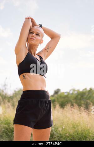 woman stretching arms in the countryside Stock Photo