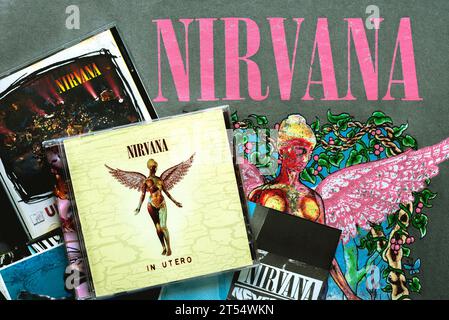 CDs of the american alternative rock group Nirvana over on a T-shirt with Nirvana logo. Illustrative editorial Stock Photo