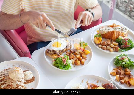 Breakfast brunch lifestyle food with hands at a cafe coffee shop. Stock Photo