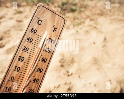 Wooden thermometer with red measuring liquid showing high temperature over  34 degrees Celsius on sunny day in shadow of trees. Concept of heat wave, w  Stock Photo - Alamy