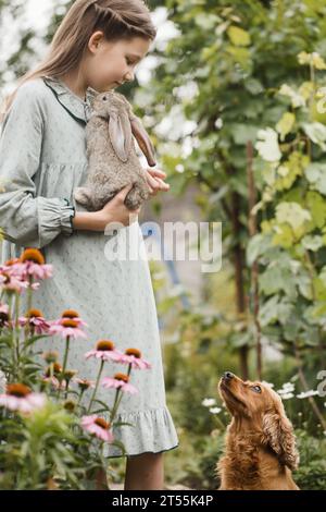 A girl with pets walks in the garden Stock Photo