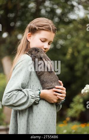A girl with a rabbit in the garden Stock Photo