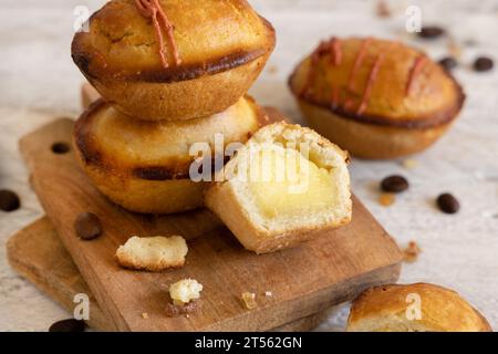 Pasticciotto leccese pastry filled with egg custard cream, typical sweet from Lecce, Italy. Pieces of pasticiotto on a wooden board, apulian breakfast Stock Photo