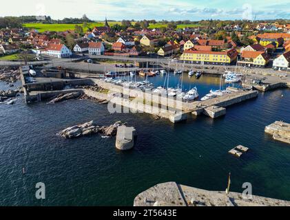 24 October 2023, Denmark, Svaneke: Town view of Svaneke, a small town on the north-eastern edge of the Danish island of Bornholm in the Baltic Sea (aerial view taken with a drone). Svaneke is the best-preserved old town on Bornholm. The island of Bornholm, together with the offshore archipelago of Ertholmene, is Denmark's easternmost island. Thanks to its location, the island of Bornholm enjoys many hours of sunshine. The island of Bornholm, together with the Ertholmene archipelago, is Denmark's easternmost island. Thanks to its location, the island of Bornholm has a particularly high number o Stock Photo