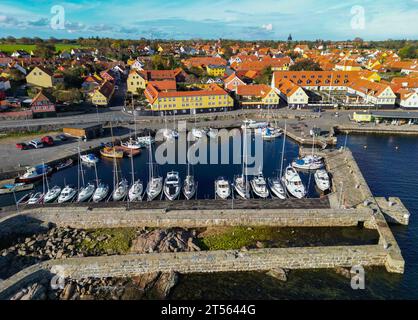 24 October 2023, Denmark, Svaneke: Town view of Svaneke, a small town on the north-eastern edge of the Danish island of Bornholm in the Baltic Sea (aerial view taken with a drone). Svaneke is the best-preserved old town on Bornholm. The island of Bornholm, together with the offshore archipelago of Ertholmene, is Denmark's easternmost island. Thanks to its location, the island of Bornholm enjoys many hours of sunshine. The island of Bornholm, together with the Ertholmene archipelago, is Denmark's easternmost island. Thanks to its location, the island of Bornholm has a particularly high number o Stock Photo