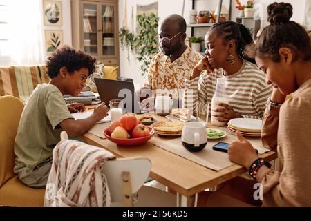 Cheerful Black family having breakfast at big table Stock Photo