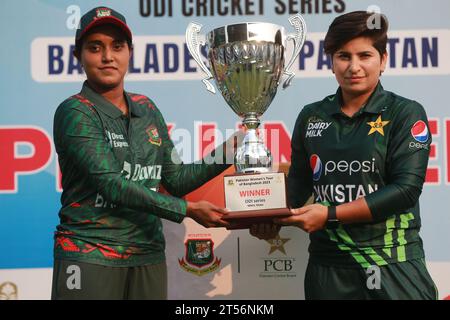 Captains of Bangladesh and Pakistan women cricket team Nigar Sultana Joty (L) and Nida Dar (R) unveil the One Day International (ODI) series Trophy at Stock Photo