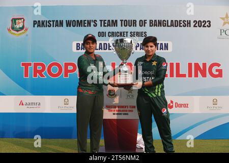 Captains of Bangladesh and Pakistan women cricket team Nigar Sultana Joty (L) and Nida Dar (R) unveil the One Day International (ODI) series Trophy at Stock Photo