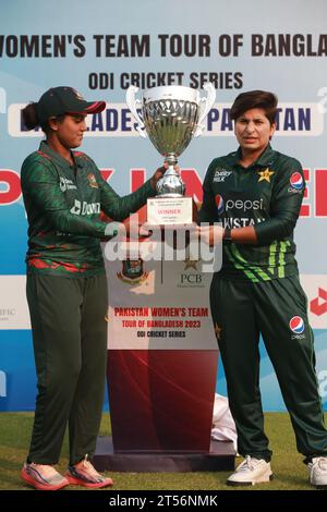 Captains of Bangladesh and Pakistan women cricket team Nigar Sultana Joty (L) and Nida Dar (R) unveil the One Day International (ODI) series Trophy at Stock Photo