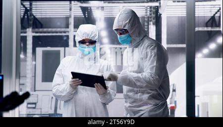 Factory Clean Room Laboratory. Industrial Engineer Using Technology Stock Photo