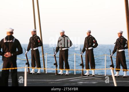 US Navy A rifle detail aboard the Nimitz-class aircraft carrier USS Carl Vinson (CVN 70) stands at parade rest during a burial a.jpg Stock Photo
