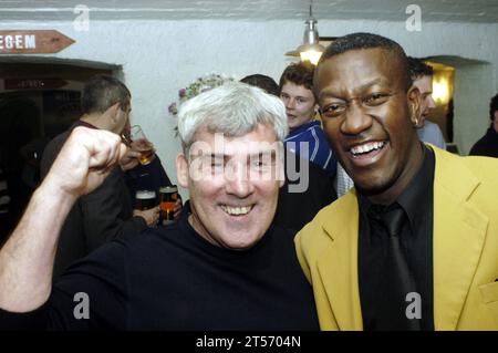 Cardiff City team celebrate their promotion from the Second Division at the Belgian Brasserie on Westgate Street on 25 May 2003. Photograph: ROB WATKINS. Pictured: City legends David Giles and Dave Bennet Stock Photo