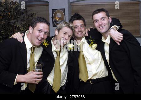 Cardiff City team celebrate their promotion from the Second Division at the Belgian Brasserie on Westgate Street on 25 May 2003. Photograph: ROB WATKINS. Pictured: (L-R) Sean Young, Andy Legg, Jason Bowen, Willie Boland Stock Photo