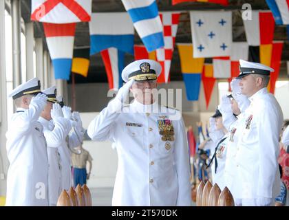 US Navy Adm. Robert. F. Willard renders a salute as he passes through side boys during a change of command ceremony at Naval Station Pearl Harbor.jpg Stock Photo