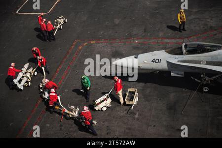 US Navy Aviation ordnancemen assigned to the Bounty Hunters of Strike Fighter Squadron (VFA) 34 prepare to upload ordnance.jpg Stock Photo
