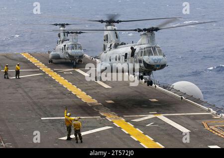 US Navy CH-46E Sea Knight helicopters assigned to Marine Medium Helicopter Squadron (HMM) 265 take off from the forward deployed.jpg Stock Photo