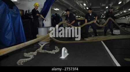 US Navy Deck department Sailors heave mooring lines in the forecastle aboard the Nimitz-class aircraft carrier USS John C. Stennis (CVN 74) during their departure from San Diego.jpg Stock Photo