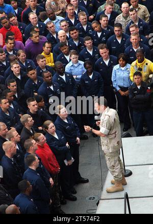 US Navy ice Adm. Bill Gortney, commander, U.S. Naval Forces Central Command and U.S. 5th Fleet, speaks to Sailors and Marines during an all-hands call on the flight deck of the amphibious assault ship USS Iwo.jpg Stock Photo