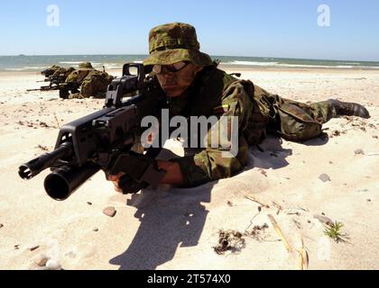 US Navy Lithuanian special forces members lie in formation on a beach during a Baltic Operations.jpg Stock Photo