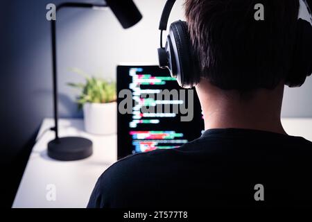 Hacker or code developer with laptop. Malware, game or website developing. Cyber criminal, programmer, engineer or coder. Fraud software or privacy. Stock Photo