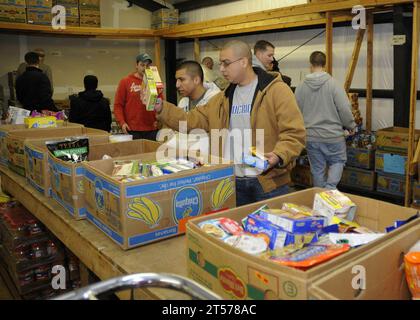 US Navy Sailors assigned to commands based at Naval Air Station Whidbey Island sort donated items for holiday baskets at North W.jpg Stock Photo