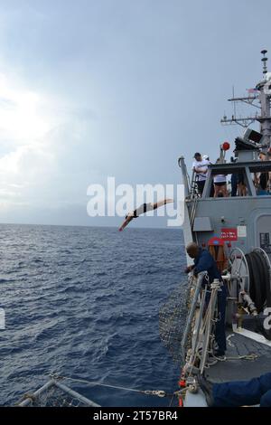 US Navy The crew of the guided-missile destroyer USS Milius (DDG 69) take a break and hold swim call while transiting in the U.S.jpg Stock Photo