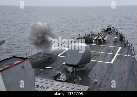 US Navy The MK 45 5-inch lightweight gun aboard the guided-missile destroyer USS Porter (DDG 78) is fired during a practice fire.jpg Stock Photo