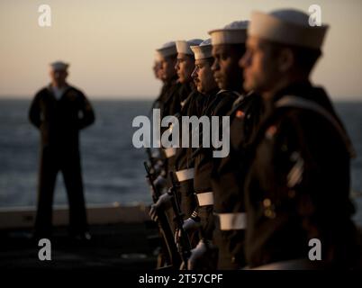 US Navy The rifle detail stands at parade rest during a burial at sea ceremony for 20 former service members aboard the Nimitz-c.jpg Stock Photo