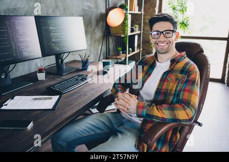 Photo young relaxed young cheerful boss man sitting leather armchair clasped hands posing confident worker in front of workplace indoors Stock Photo