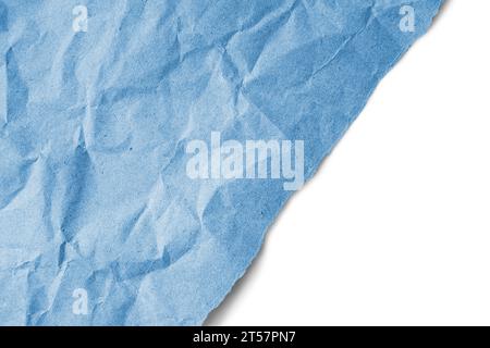 Recycled crumpled blue paper texture with a diagonal torn edge isolated on white background. Wrinkled and creased abstract backdrop, wallpaper with co Stock Photo