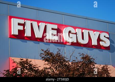 Bronx, NY - November 2, 2023: Five Guys fast food chain restaurant exterior name brand signage Stock Photo