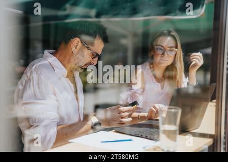 Collaborative Business Workshop: Multicultural Leaders Discussing Better Results and Efficiency Stock Photo