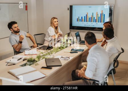 Multigenerational Business Team Collaborating on Profit Growth Analysis Stock Photo