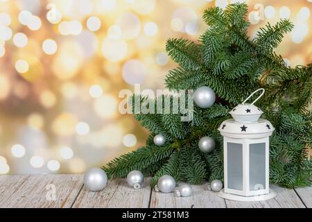 christmas and New year background. lantern and stars near the decorated Christmas tree on the wall with garlands of lights Stock Photo