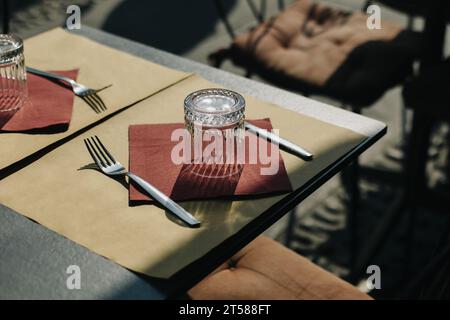 Table served for lunch in a street cafe on a sunny day. Selective focus. Stock Photo
