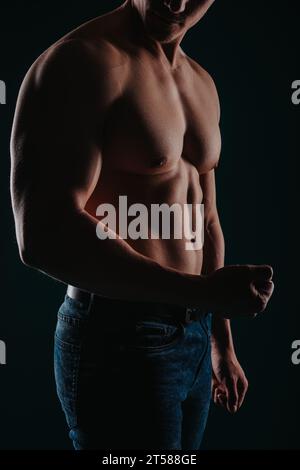 Good looking naked man with six pack abs and blue eyes eyes lying naked