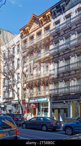 249 and 251 East 77th Street are mirror twin five-story brownstone apartment buildings with ground floor stores in the Upper East Side. Stock Photo