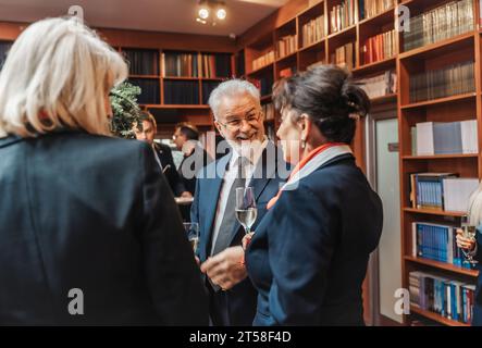 A diverse business team celebrates achievements and success at a vibrant party, toasting to a successful year and project completion. Stock Photo