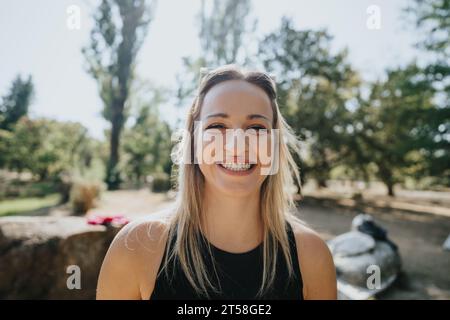 A carefree socializes in a city park on a sunny day. They enjoy nature and embrace positivity while spending time with best friends. Stock Photo