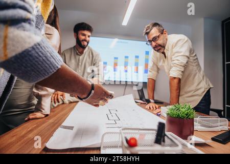 International Team of Architects and Engineers Collaborating on Innovative Project in Boardroom Stock Photo