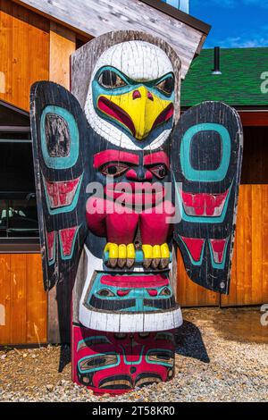 Hoonah, Icy Strait Point, Alaska USA-June 29, 2019: Colorful Tlingit carved totem pole exhibited in downtown Hoonah. Stock Photo