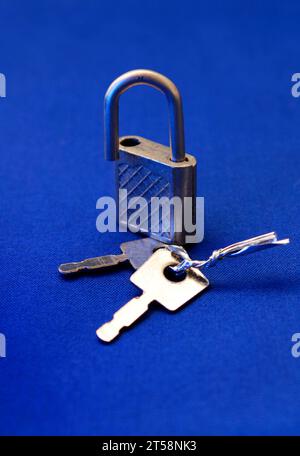 Open padlock on blue background Stock Photo