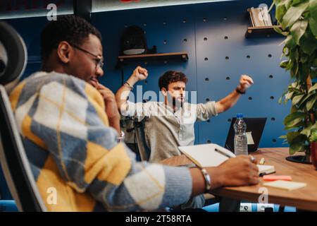 Successful Collaboration in a Modern Co-Working Space: Diverse Professionals Solving Problems and Growing Their Small Company Stock Photo