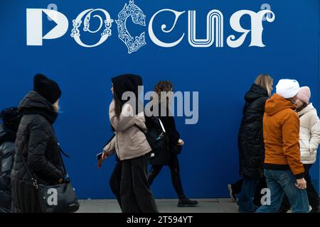 Moscow, Russia. 3rd of November, 2023. People walk past the logotype of Russia Expo exhibition, designed to demonstrate Russia's main achievements in culture and technology at the All-Russia Exhibition Centre (VDNKh) in Moscow city, Russia. The exhibition will start on November 4 and will untill April 12, 2024. Credit: Nikolay Vinokurov/Alamy Live News Stock Photo