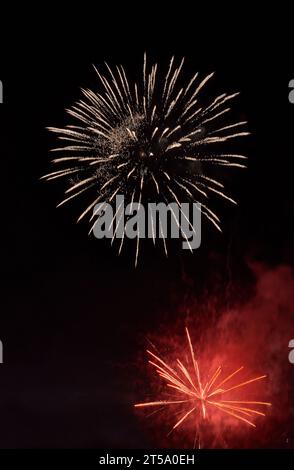 Silver firework with smoke over the black sky background. Low key exposure. Selective focus. Stock Photo