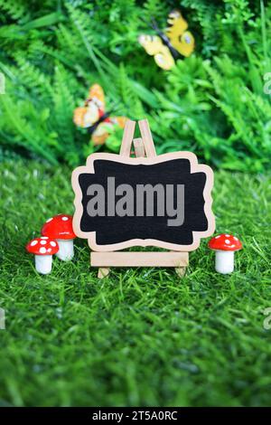 Mini Chalkboard on Easel with Garden Background Stock Photo