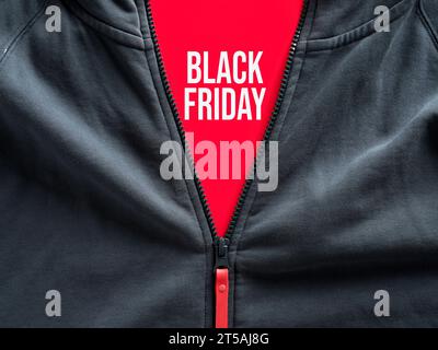 Opened zipper of a hoodie showing the word black Friday on a tag. Black Friday sale in fashion and casual sportwear clothing. Stock Photo